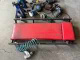 a red bench with tools on it in a garage