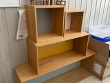 a wooden shelf with two chairs on top of it