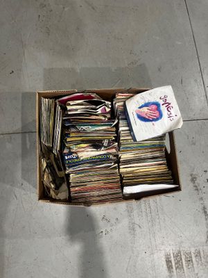 a cardboard box full of cds on the floor