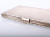 a silver book sitting on top of a white table