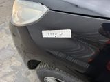 a black car with a white sticker on the front of it