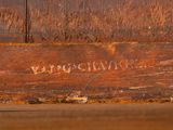 a close up of a piece of wood with writing on it