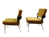pair of vintage lounge chairs with upholstered backrests