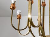 a close up of a brass chandelier hanging from the ceiling