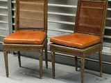 these are two chairs sitting next to each other in front of a wall