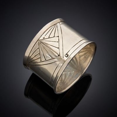 a close up of a silver ring on a black surface