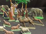 many figurines of people and animals on the table