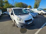 a white van parked in a parking lot next to other cars