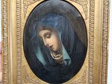 painting of a woman with a pipe in her mouth in a gold frame