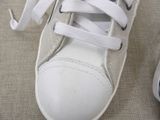 a close up of a pair of white shoes with white laces