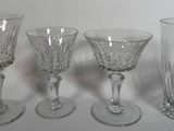 three wine glasses sitting next to each other on a table
