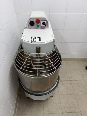 a mixer in the corner of a bathroom with a number on it
