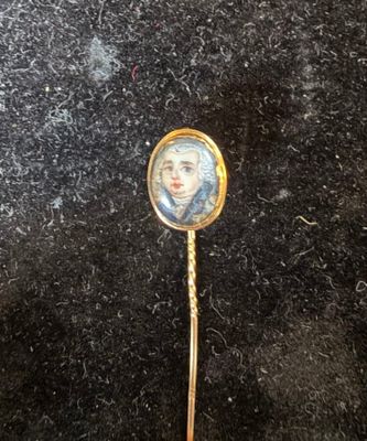 an image of a gold stick with a picture of a woman on it