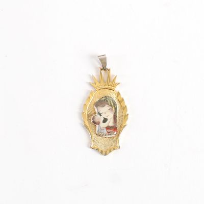an image of a gold pendant with a picture of a woman holding a baby