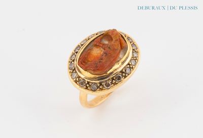 an image of a gold ring with a red stone in it