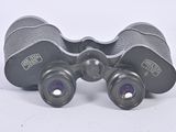 an image of a pair of binoculars sitting on top of a table