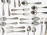 a lot of silver spoons and forks on the table