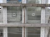 a stack of old windows sitting on a pallet