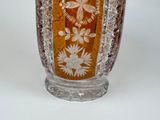 a glass vase with a floral design on it