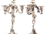a pair of silver plated candelabs with flowers and leaves