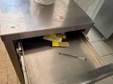 a roll of toilet paper sitting in a drawer in a kitchen