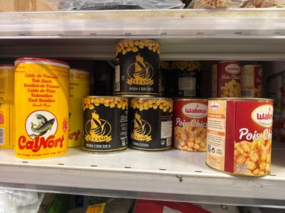 de nombreuses boîtes de conserve sur une étagère dans un magasin