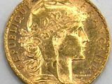 a close up of a gold coin with a woman ' s head on it