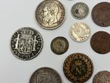 some coins are sitting on top of a white surface