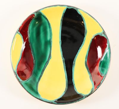a close up of a colorful bowl on a white surface