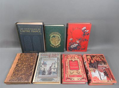several books are lined up in a row on a gray surface