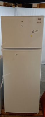 a white refrigerator sitting in the corner of a room