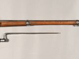 an old rifle with a wooden handle and a wooden handle