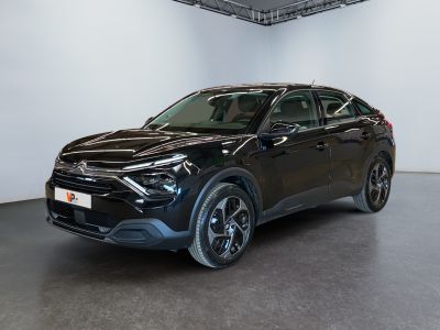 a black suv parked in a white room with a black floor
