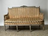 a couch that is sitting on a carpeted floor