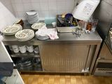 a kitchen with a lot of dishes and dishes on the counter