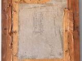 an old picture frame with a piece of paper on top of it