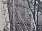 a black and white photo of a large building with a tarp covering it