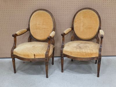 pair of antique chairs with upholstered back and arms