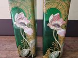 two vases that are sitting on a wooden table