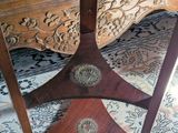 a wooden table with a drawer underneath it on a rug