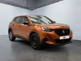 the orange car is parked in a large room with a black floor