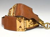 brown leather belt with brass buckle on white background