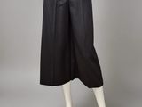 a woman ' s black skirt with buttons and buttons on the waist