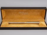 a silver ballpoint pen in a black box with gold trim