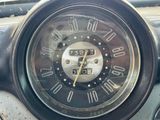 a close up of a clock on the dashboard of a car