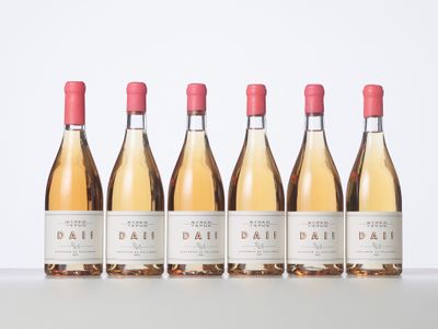 three bottles of wine are lined up on a table