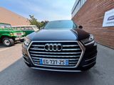 l'avant d'une Audi noire garée devant un immeuble