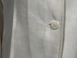 a close up of a white shirt with buttons on it
