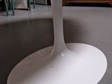 a white table with a glass top in a room
