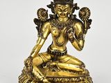 a gold statue of a woman sitting on a lotus